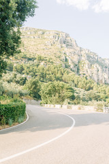 The coast of Positano, Amalfi in Italy. Panorama of the evening city and the streets with shops and cafes. Houses by the sea and the beach. Ancient architecture and temples