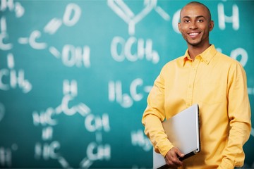 Smiling African Student man with laptop