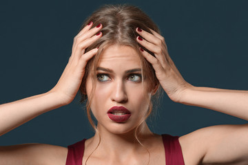 Naklejka premium Fashionable young woman with beautiful manicure on color background