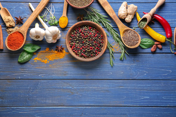 Composition with different spices on wooden background