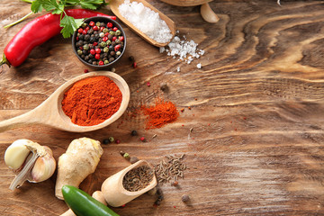 Composition with different spices on wooden background