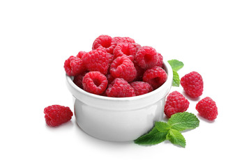 Bowl with ripe raspberries on white background