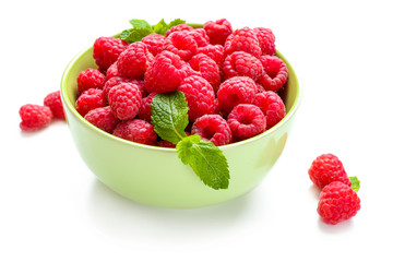 Bowl with ripe raspberries on white background