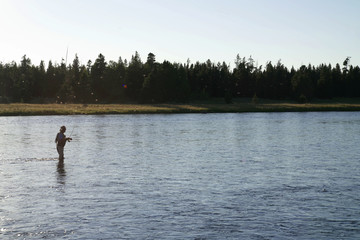 Fototapeta na wymiar Fisherman flyfishing in river of Idaho state