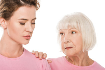 senior woman supporting upset woman isolated on white, breast cancer concept