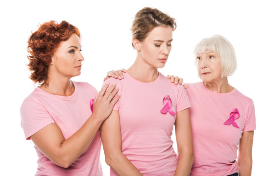 women in pink t-shirts supporting upset woman isolated on white, breast cancer concept
