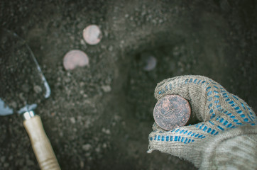 Aged 5 kopeks coin of Russian empire in the hand of coin finder. Treasure hunting concept. In search of a lost treasure.