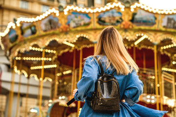 portrait of a girl in American style on a swing laughs and rejoices