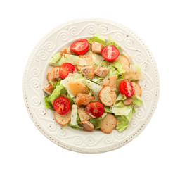 Plate with tasty Caesar salad on white background