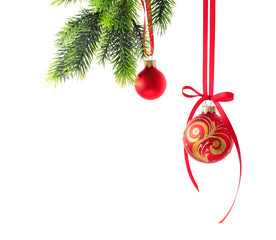 Christmas balls hanging on fir-tree branch against white background