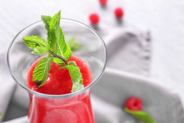 Glass of tasty raspberry smoothie, closeup