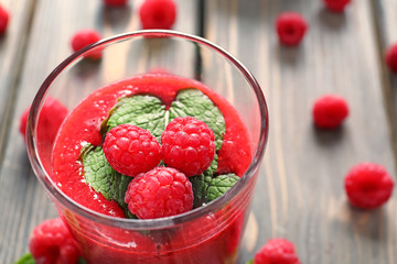 Glass of tasty raspberry smoothie, closeup
