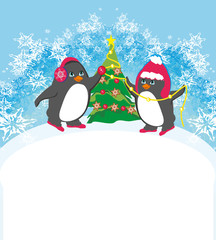 funny penguins decorating christmas tree