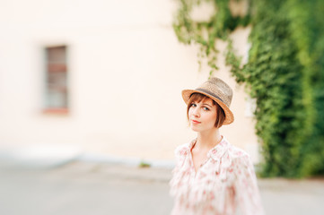 Portrait of a beautiful woman in a straw hat. Young girl. Summer time