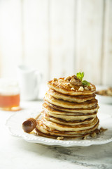 Fototapeta na wymiar Pancakes with honey and nuts