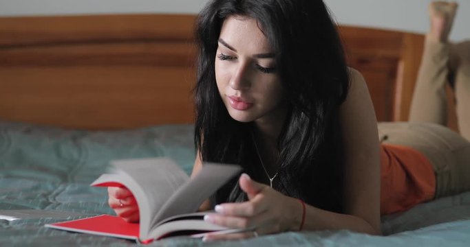 Woman reading book in home bed