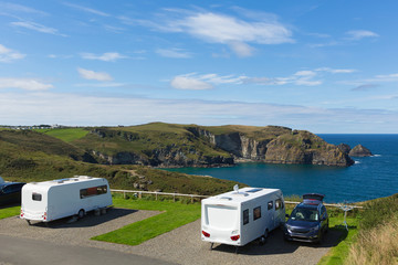 Caravans on a pitch by a beautiful coast scene