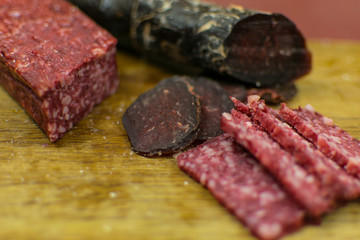 Smoked sausages are cut on a cutting board.
