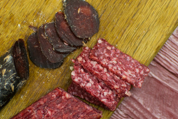 Smoked sausages are cut on a cutting board.