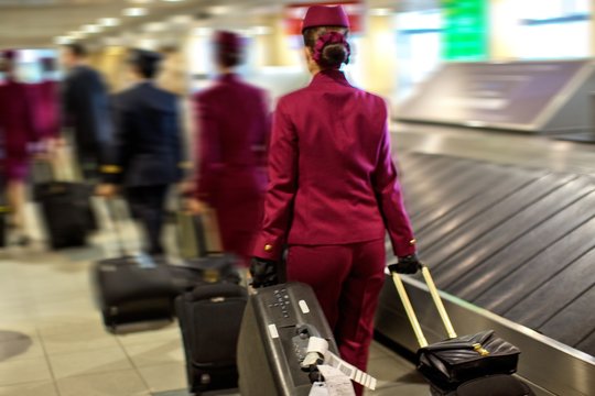 Cabin Crew In An Airport Carrying Their Luggage