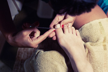 Obraz premium Female pedicure. Care for feet and toenails. Master conducts procedures for foot care.