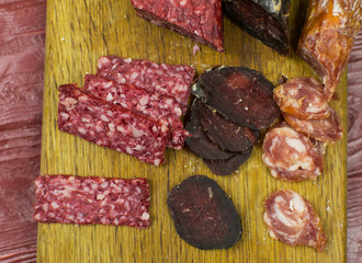 Smoked sausages are cut on a cutting board.