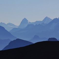 Mountain peaks of the Bernese Oberland at sunrise. View from Glacier 3000, Switzerland.
