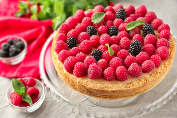 Delicious cheesecake with raspberries on table