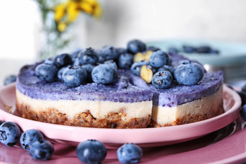 Tasty cheesecake with blueberries on plate, closeup