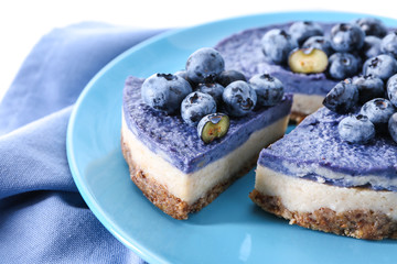 Tasty cheesecake with blueberries on plate, closeup