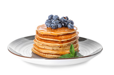 Plate with tasty pancakes and blueberries on white background