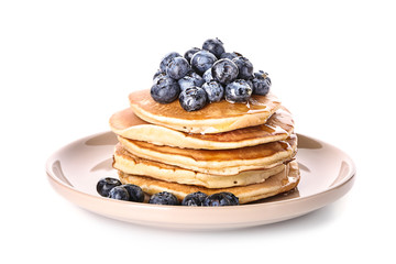 Plate with tasty pancakes and blueberries on white background