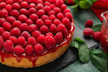 Delicious raspberry cheesecake on table, closeup