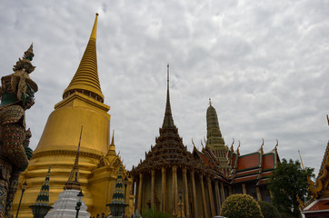 Fototapeta na wymiar Temple buildings in the Grand Palace of Bangkok, Thailand on a cloudy day