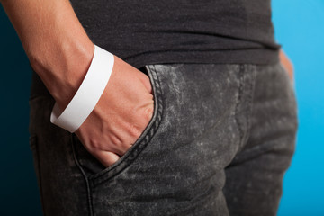 Paper wristband mockup, event bracelet on hand. Empty ticket wrist band design.