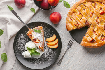 Composition with tasty homemade peach pie on table