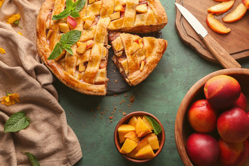 Composition with tasty homemade peach pie on table