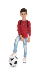 Playful little boy with soccer ball on white background