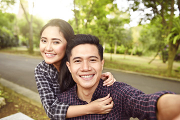 Two asian lovers making a selfie on phone