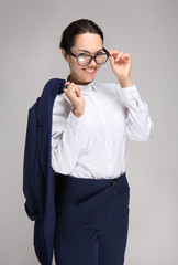 Beautiful businesswoman on grey background