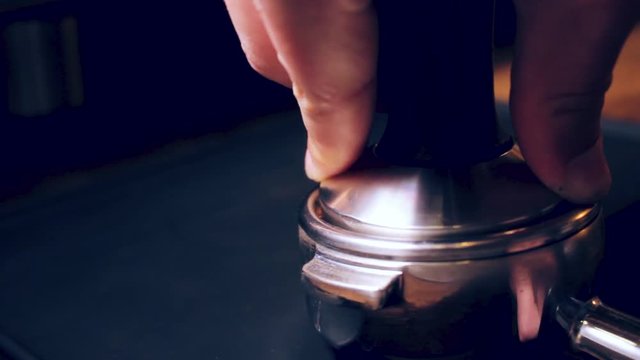 Process of making coffee-Tamping.