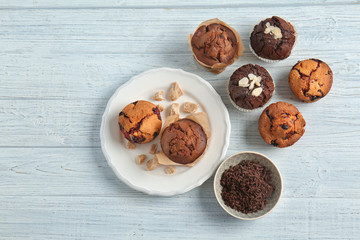 Tasty muffins on white wooden table