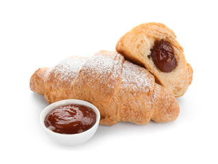 Tasty croissants with jam on white background