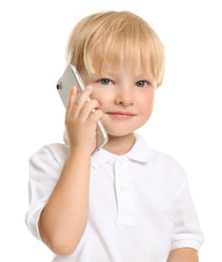 Cute little boy talking on mobile phone against white background