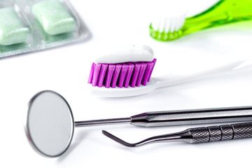 dental care toothbrush with dentist tools on white background