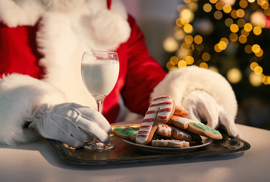 Santa Claus Eating Cookies And Drinking Milk At Table, Closeup