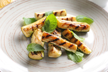 Tasty grilled zucchini on plate, closeup