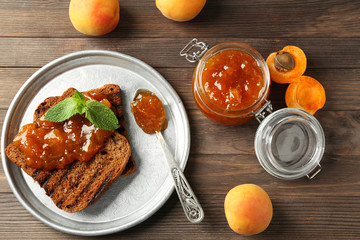 Toasted bread with delicious apricot jam on plate