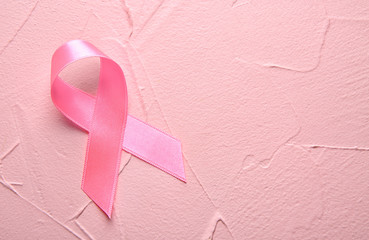 Pink ribbon on color background. Breast cancer concept