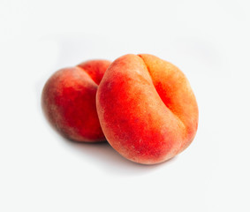 Fototapeta na wymiar Saturn Peach isolated on white background. Flat peaches, two doughnut peaches in a pile.